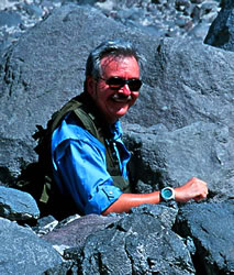 Scott surrounded by fresh lava blocks from a pyroclastic flow; Arenal Volcano, Costa Rica